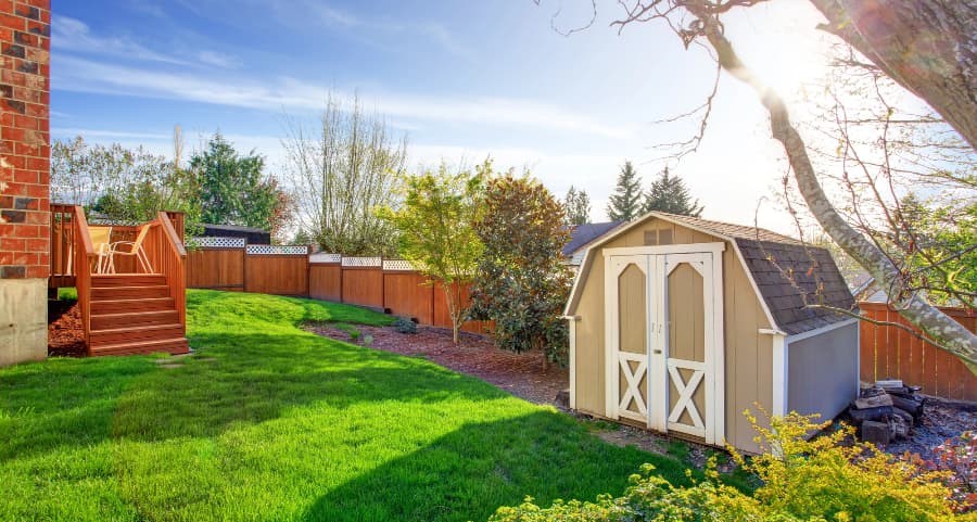 Fenced backyard with storage shed in Peoria