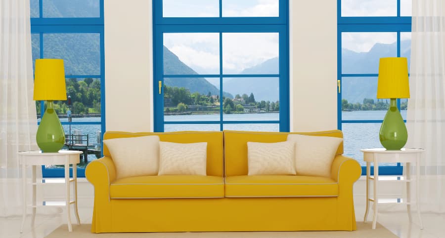 Image of family room windows behind sofa with coordinating tables and lamps